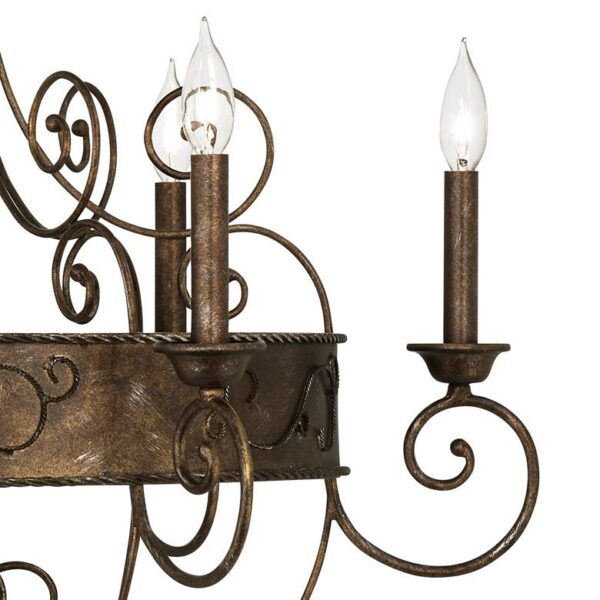 A close-up of a rustic chandelier with six candle sleeves made of wrought iron. The candle sleeves are filled with candles that are burning, creating a warm and inviting glow.