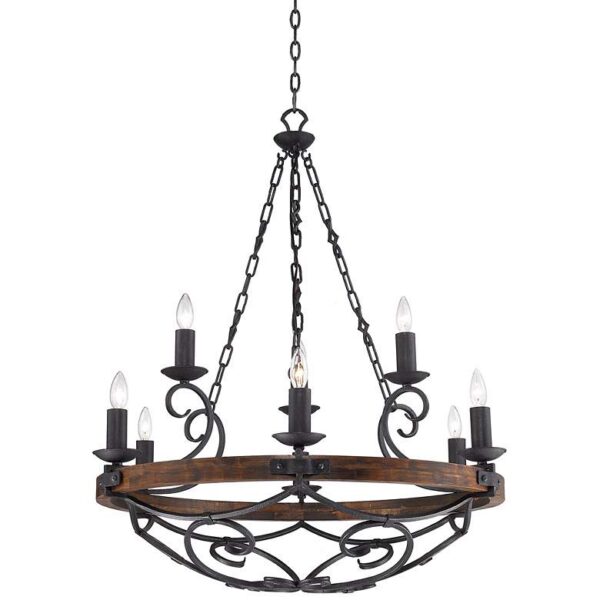 A product image of a Golden Lighting Madera 9-Light Chandelier 1821-9 BI. The chandelier is made of wrought iron and has a wooden base. It is hanging from the ceiling in a living room. The chandelier has nine lights, each with a candle sleeve shade. The candles are lit and are casting a warm glow.