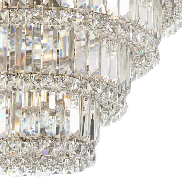 A close-up of a silver chandelier with clear crystal accents. The chandelier has a round base and is made up of many small crystals. The crystals are arranged in a symmetrical pattern.