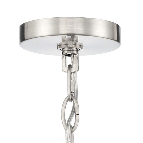 Close-up of a silver light fixture with a chain attached to it. The light fixture is made of metal and has a round base. The chain is made of metal and is attached to the ceiling.