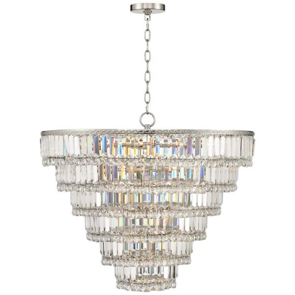 A silver chandelier with clear crystal accents hangs from the ceiling in a dining room. The chandelier has a round base and is made up of many small crystals. The crystals are arranged in a symmetrical pattern.