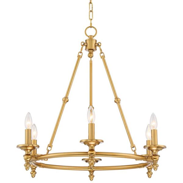 A brass chandelier hanging from a chain. The chandelier has a wagon wheel shape and is made of warm antique brass. It has six lights that are evenly spaced around the wheel.