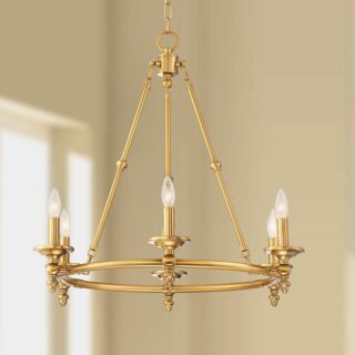 A brass chandelier with six candles, perfect for a farmhouse kitchen or dining room. The candles are lit and provide a warm and inviting glow.