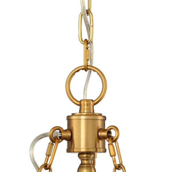 Close up of a brass pendant light with chains hanging from it on a white background.