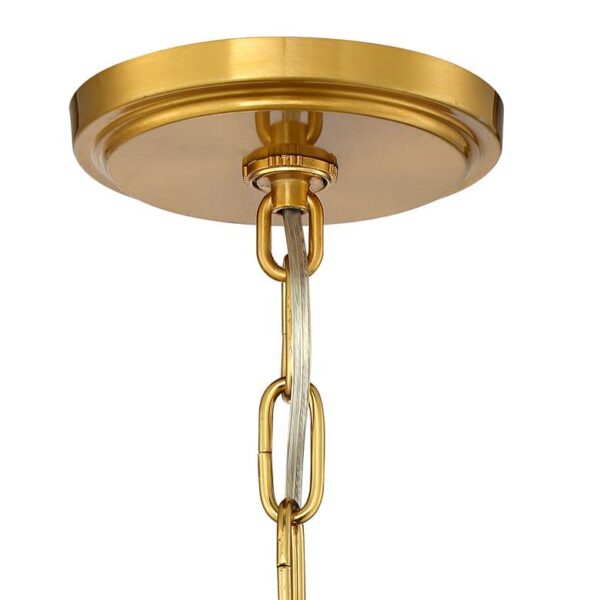 Close up of a Possini Euro Design Prava Warm Brass Pendant Chandelier with a chain attached to it on a white background.