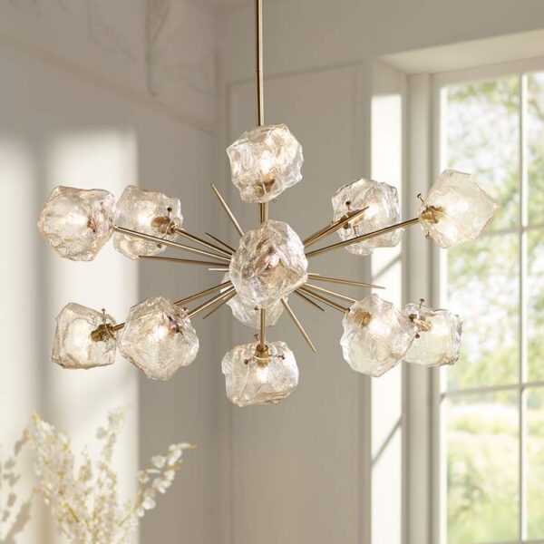 A golden bronze chandelier with clear ice glass globes hanging from the ceiling. The chandelier is suspended from a chain and has a decorative finial at the top. The image is taken in a room with a white ceiling and light-colored walls.