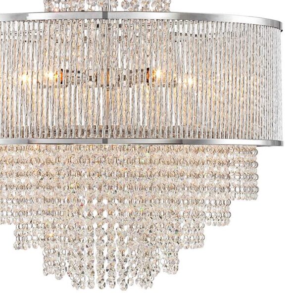 A product image of a Pioggia Chrome 23 1/2 Wide Crystal Chandelier. The chandelier is made of crystals and has a round base. It is hanging from the ceiling in a white room. The crystals are arranged in a cascading pattern and are sparkling in the light.